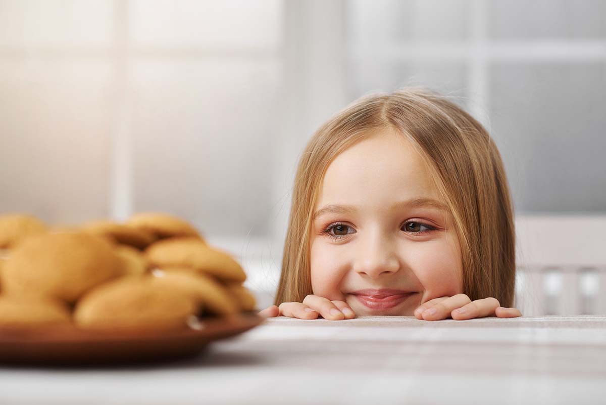 girl looking at cookies